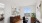 Bright and modern home office with a scenic city view, sleek wooden desk, and minimalist artwork
