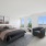 Bright and spacious bedroom with a plush bed, modern furniture, and large windows offering stunning views.