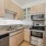 Contemporary kitchen design with lots of storage space and modern appliances.