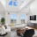 Bright and airy living room with high ceilings, elegant sectional sofa, and stunning city views through large windows.