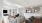 Modern open-concept living space featuring a cozy gray sectional, sleek kitchen with stainless steel appliances, and a stylish dining area with a wooden table.