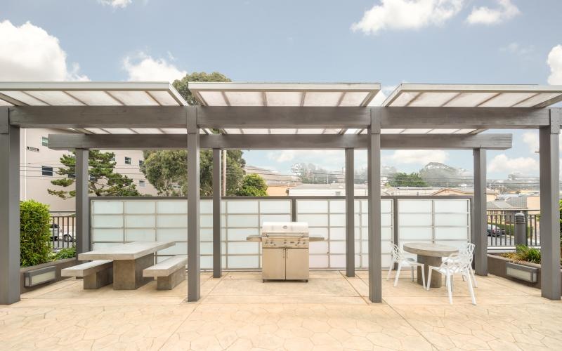 a covered patio with benches